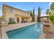 Expansive backyard featuring a pool, covered patio, lush landscaping, and ample space for outdoor activities and relaxation at 4630 E Hazeltine Way, Chandler, AZ 85249