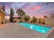Beautiful backyard pool featuring a stone water feature, adjacent to a covered outdoor patio with a fire pit at 4630 E Hazeltine Way, Chandler, AZ 85249