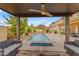 A lovely outdoor living space featuring a covered patio with a ceiling fan overlooking a pristine pool at 4630 E Hazeltine Way, Chandler, AZ 85249