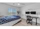 Cozy bedroom featuring a window, ceiling fan and a functional desk area at 4630 E Hazeltine Way, Chandler, AZ 85249