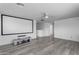 Spacious bonus room featuring a large screen projector setup and neutral decor at 4630 E Hazeltine Way, Chandler, AZ 85249