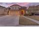 Inviting two-story home featuring a stone entryway and a well-manicured lawn at 4630 E Hazeltine Way, Chandler, AZ 85249