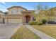 Lovely two-story home boasts a stone-detailed entryway, a welcoming front yard, and a wide driveway at 4630 E Hazeltine Way, Chandler, AZ 85249