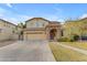 Charming two-story home featuring a stone-accented entrance and well-manicured front yard, showcasing its curb appeal at 4630 E Hazeltine Way, Chandler, AZ 85249