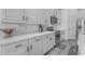 Modern white kitchen with stainless appliances and quartz countertops at 4630 E Hazeltine Way, Chandler, AZ 85249