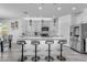 Bright white kitchen island with quartz countertops, stainless appliances, and modern pendant lighting at 4630 E Hazeltine Way, Chandler, AZ 85249