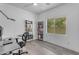 Bright office space with a bookshelf, large window, and a modern chair setup at 4630 E Hazeltine Way, Chandler, AZ 85249