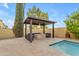 Inviting covered patio space with a cozy seating area and fire pit, adjacent to the pool, perfect for outdoor gatherings at 4630 E Hazeltine Way, Chandler, AZ 85249
