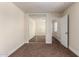 Bedroom featuring carpeted floor, closet with mirror sliding doors, and a door to the hallway at 4659 E Pinto Valley Rd, San Tan Valley, AZ 85143