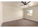 Bright bedroom featuring neutral walls, carpet flooring and a ceiling fan, complete with a window view at 4659 E Pinto Valley Rd, San Tan Valley, AZ 85143