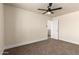 Bedroom showcasing neutral walls, carpet flooring, a ceiling fan, and access to a doorway at 4659 E Pinto Valley Rd, San Tan Valley, AZ 85143