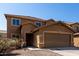 Two-story home featuring a two-car garage and landscaped front yard at 4659 E Pinto Valley Rd, San Tan Valley, AZ 85143