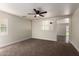 Spacious living room with neutral walls and carpeted flooring, and a ceiling fan at 4659 E Pinto Valley Rd, San Tan Valley, AZ 85143