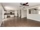 Open-concept living space with neutral walls, tile flooring, and kitchen view at 4659 E Pinto Valley Rd, San Tan Valley, AZ 85143