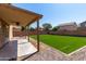 Covered patio overlooking a spacious backyard with artificial grass, ideal for entertaining and relaxation at 4659 E Pinto Valley Rd, San Tan Valley, AZ 85143