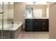 Elegant bathroom featuring double sinks, marble countertops, and a soaking tub for ultimate relaxation at 4803 N Woodmere Fairway -- # 1003, Scottsdale, AZ 85251