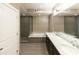 Modern bathroom with double sinks, a soaking tub, and a glass-enclosed shower, designed for relaxation at 4803 N Woodmere Fairway -- # 1003, Scottsdale, AZ 85251