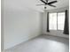 Minimalist bedroom with white walls, large window, and gray curtains at 4803 N Woodmere Fairway -- # 1003, Scottsdale, AZ 85251