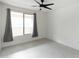 Bright, spacious bedroom with a window, ceiling fan, and modern window coverings at 4803 N Woodmere Fairway -- # 1003, Scottsdale, AZ 85251
