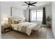 Inviting bedroom with large window, ceiling fan, neutral decor, and stylish furnishings at 4803 N Woodmere Fairway -- # 1003, Scottsdale, AZ 85251
