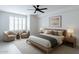 This modern bedroom features a ceiling fan, neutral decor, and ample natural light creating a serene and stylish space at 4803 N Woodmere Fairway -- # 1003, Scottsdale, AZ 85251