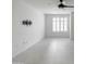 Bright room with modern tile flooring, a ceiling fan, and a wall-mounted TV bracket for easy setup at 4803 N Woodmere Fairway -- # 1003, Scottsdale, AZ 85251