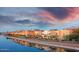 Waterfront condos reflecting on the water with a colorful sunset at 4803 N Woodmere Fairway -- # 1003, Scottsdale, AZ 85251