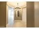 Elegant foyer boasts a decorative light fixture, and mirrors adding a touch of sophistication at 4803 N Woodmere Fairway -- # 1003, Scottsdale, AZ 85251
