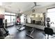 Community gym with weightlifting machines, free weights, and a mirrored wall at 4803 N Woodmere Fairway -- # 1003, Scottsdale, AZ 85251