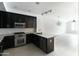 Modern kitchen featuring sleek black cabinetry, stainless steel appliances, and granite counters at 4803 N Woodmere Fairway -- # 1003, Scottsdale, AZ 85251