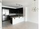 Modern kitchen featuring sleek black cabinetry, stainless steel appliances, and a large island at 4803 N Woodmere Fairway -- # 1003, Scottsdale, AZ 85251