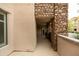 Private covered patio featuring stone accents, neutral colors and an outdoor entryway at 4803 N Woodmere Fairway -- # 1003, Scottsdale, AZ 85251