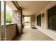 Spacious covered patio featuring stone accents, neutral colors, and an additional storage closet at 4803 N Woodmere Fairway -- # 1003, Scottsdale, AZ 85251