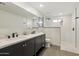 Stylish bathroom with double sink vanity, sleek black hardware, and glass enclosed shower at 4907 E Piccadilly Rd, Phoenix, AZ 85018