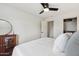 Well-lit bedroom features wood floors, closet, and a decorative mirror on top of a wooden cabinet at 4907 E Piccadilly Rd, Phoenix, AZ 85018
