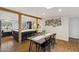 Open dining area with wood floors and easy access to the updated kitchen with large island at 4907 E Piccadilly Rd, Phoenix, AZ 85018