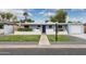 Charming single-story home features a manicured front yard and a lovely, light blue painted facade at 4907 E Piccadilly Rd, Phoenix, AZ 85018