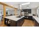 Bright, open kitchen boasts a large island with cooktop, stainless steel appliances, and modern finishes at 4907 E Piccadilly Rd, Phoenix, AZ 85018