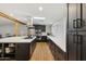 Modern kitchen boasts dark cabinetry, stainless steel appliances, a skylight, and a stylish backsplash at 4907 E Piccadilly Rd, Phoenix, AZ 85018