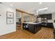 Modern kitchen boasts dark cabinetry, stainless steel appliances, a skylight, and a stylish backsplash at 4907 E Piccadilly Rd, Phoenix, AZ 85018