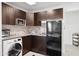 Modern kitchenette with microwave, cabinets, refrigerator, and laundry machines at 4907 E Piccadilly Rd, Phoenix, AZ 85018