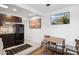 A modern kitchenette features dark cabinets, appliances, and a mounted television screen at 4907 E Piccadilly Rd, Phoenix, AZ 85018
