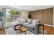 Comfortable living room features wood-look floors, accent wall, and a large window with a view of yard at 4907 E Piccadilly Rd, Phoenix, AZ 85018