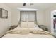 Main bedroom featuring a neutral color palette, and a walk in closet with gray curtains at 4907 E Piccadilly Rd, Phoenix, AZ 85018