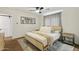 Main bedroom includes a bed with a beige headboard, wood floor and gray curtains at 4907 E Piccadilly Rd, Phoenix, AZ 85018