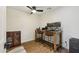 Office area with a rustic wooden desk, two monitors, leather chairs and a wooden cabinet at 4907 E Piccadilly Rd, Phoenix, AZ 85018