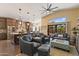 Open concept living room featuring kitchen with large island, breakfast bar, seating area, and sliding doors to the patio at 4932 S Verbena Ave, Gilbert, AZ 85298