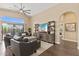 Living Room features high ceiling, entertainment center, and sliding glass doors to the backyard at 4932 S Verbena Ave, Gilbert, AZ 85298