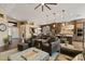 Spacious living room with kitchen view, ceiling fan, recessed lighting, and hardwood flooring at 4932 S Verbena Ave, Gilbert, AZ 85298