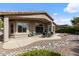 Relaxing covered patio with comfortable seating and landscaped backyard at 4932 S Verbena Ave, Gilbert, AZ 85298